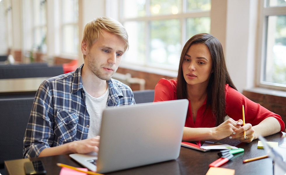 Two students studying together on a laptop for TEAS exam help and preparation